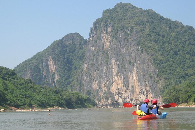 FULL DAY – Kuang Si Waterfall, Kayak on the Nam Ou / Mekong River, Pak Ou Caves - Paddling the Nam Ou below the limestone cliffs