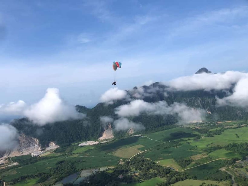 Vang Vieng: Paragliding Experience with Hotel Pickup - Taking to the air above Vang Vieng